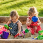 the-two-little-baby-girls-playing-toys-in-sand_200.jpg